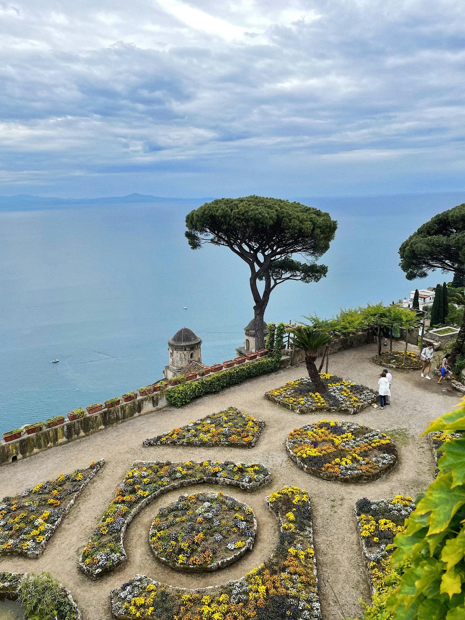 Formal flower gardens and umbrella pines poised high above the sea in Ravello