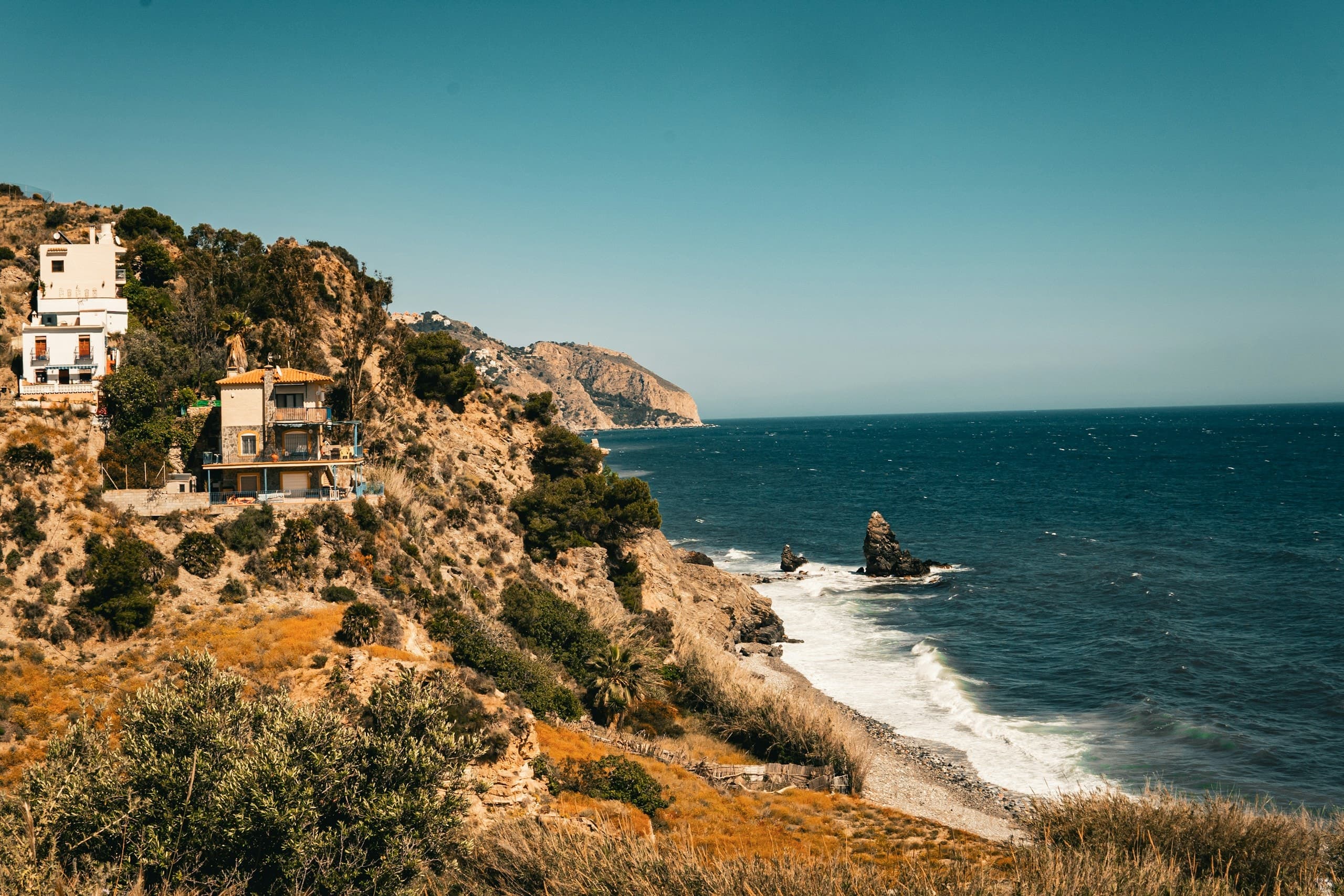 a house on a cliff overlooking the ocean