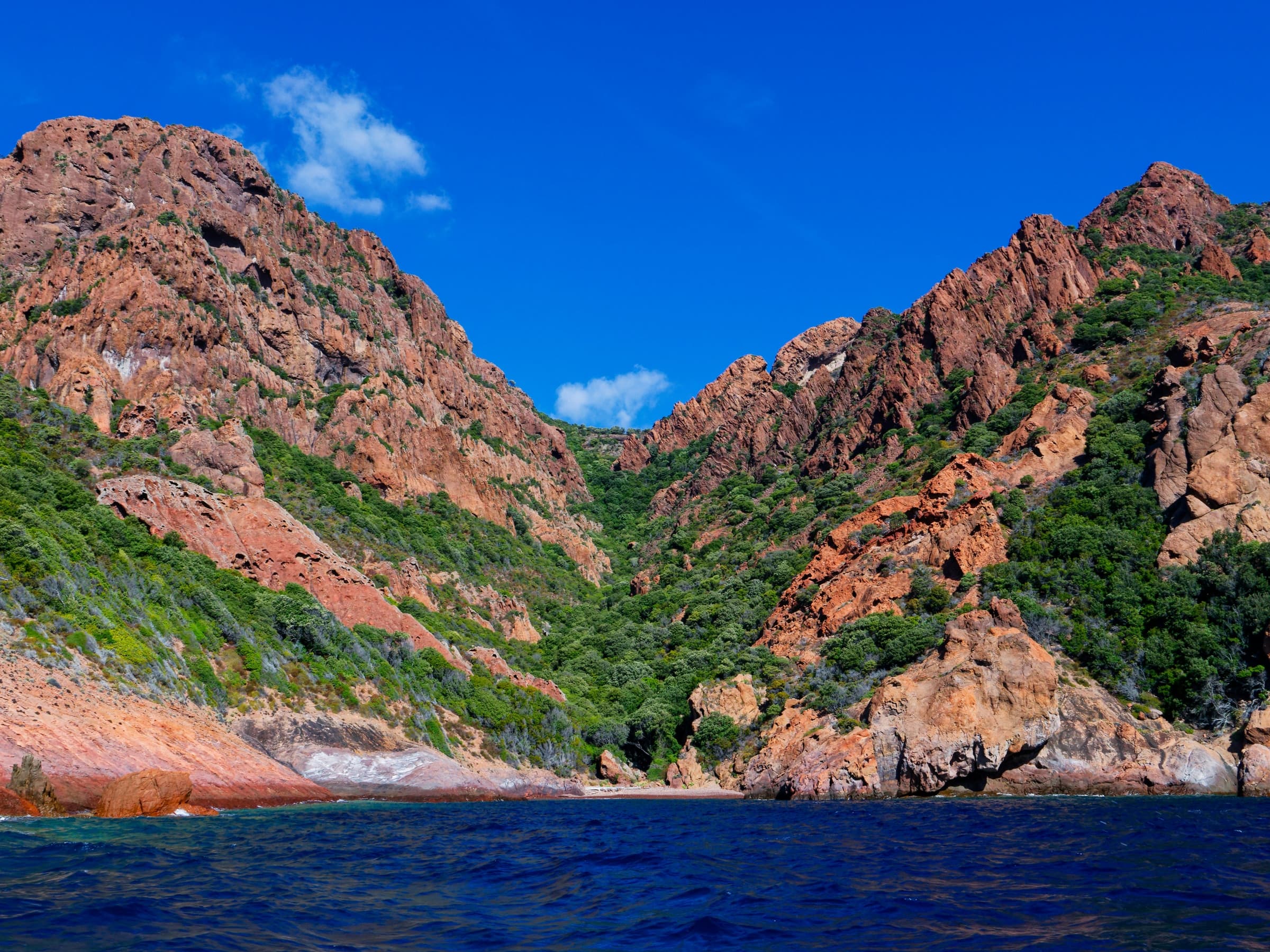 Scandola's red granite cliffs plunging into deep blue Mediterranean water