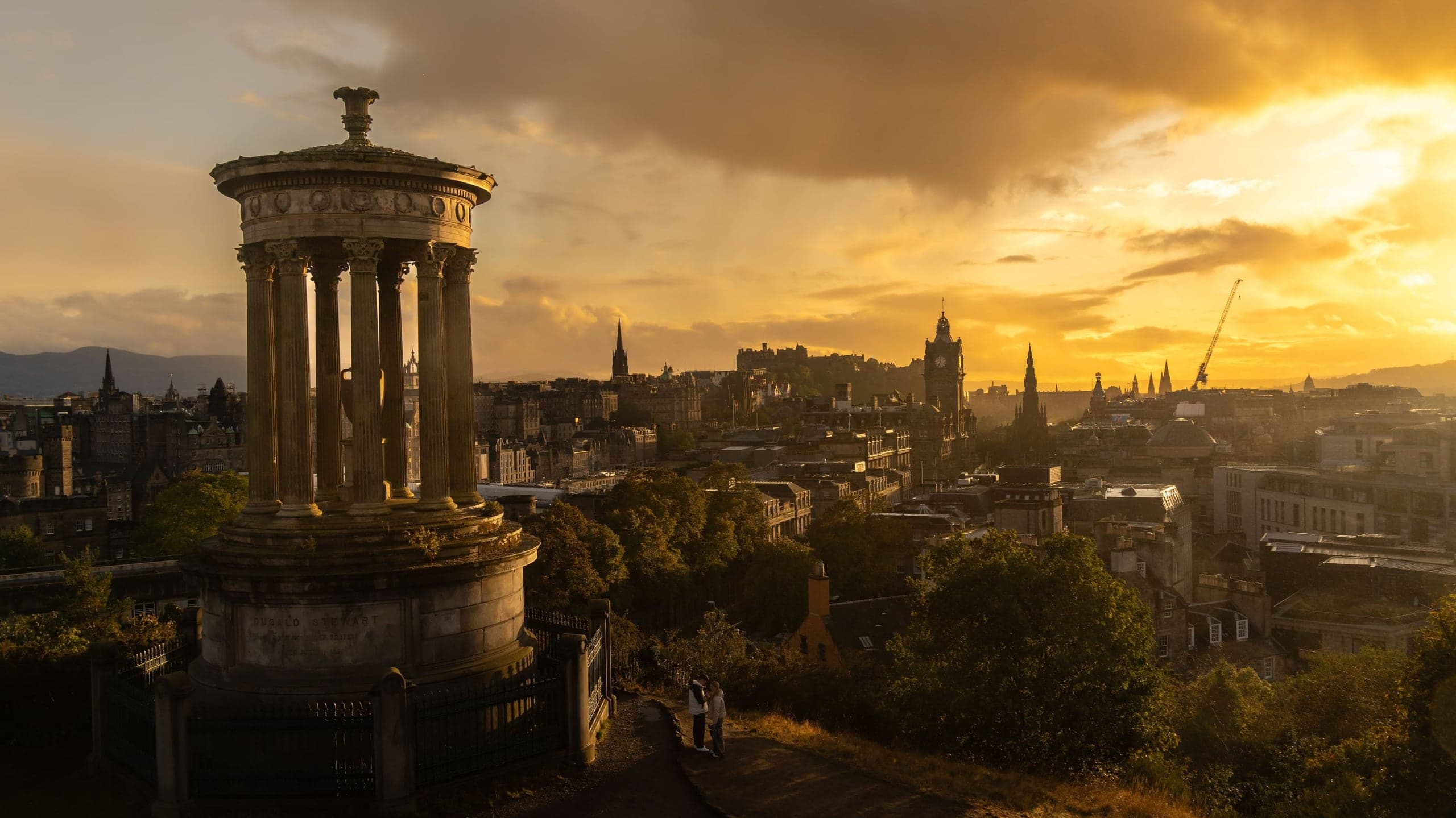 Dugald Stewart Monument and Edinburgh Castle glowing at sunset
