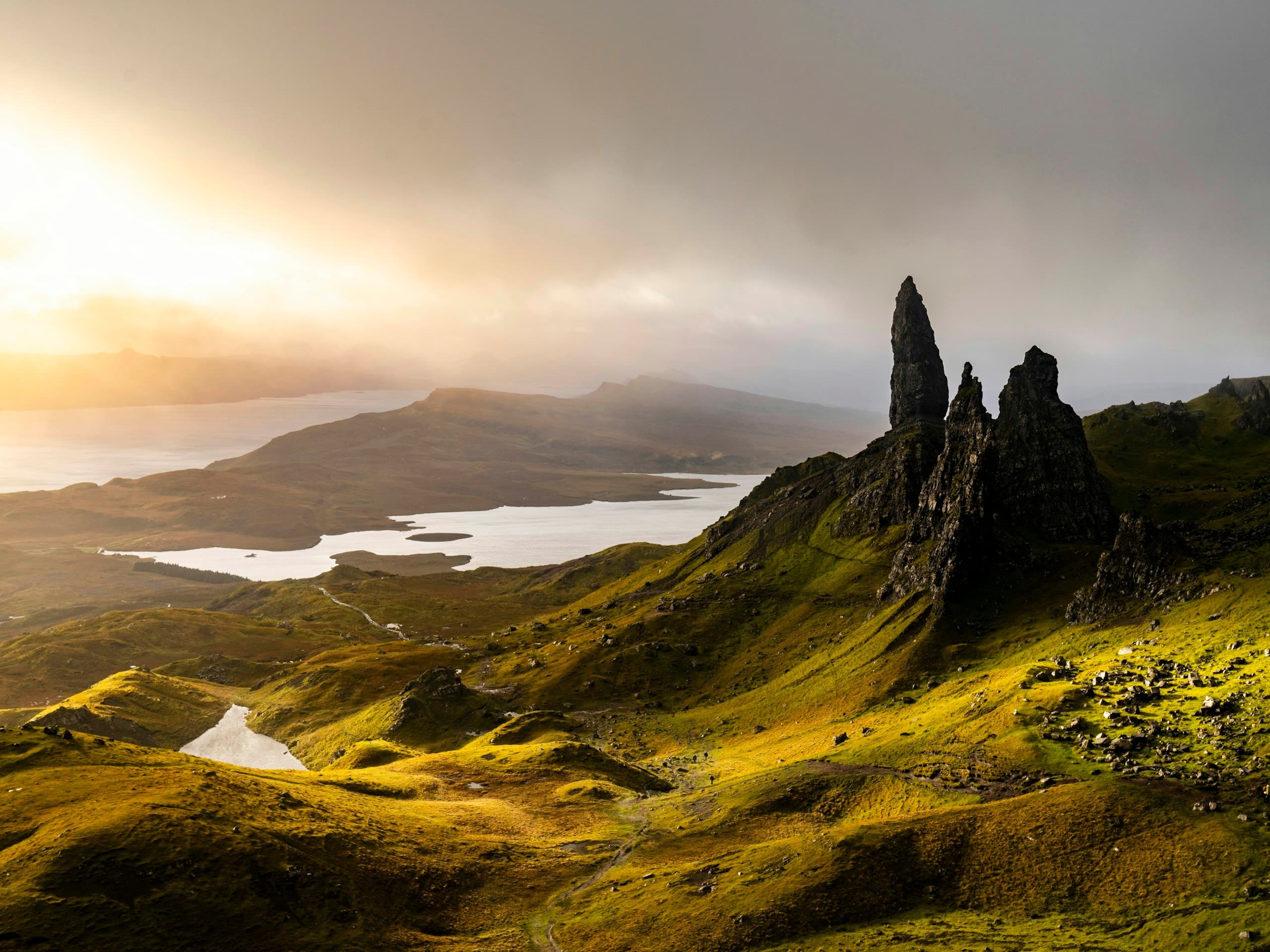 a mountain range with a body of water in the distance