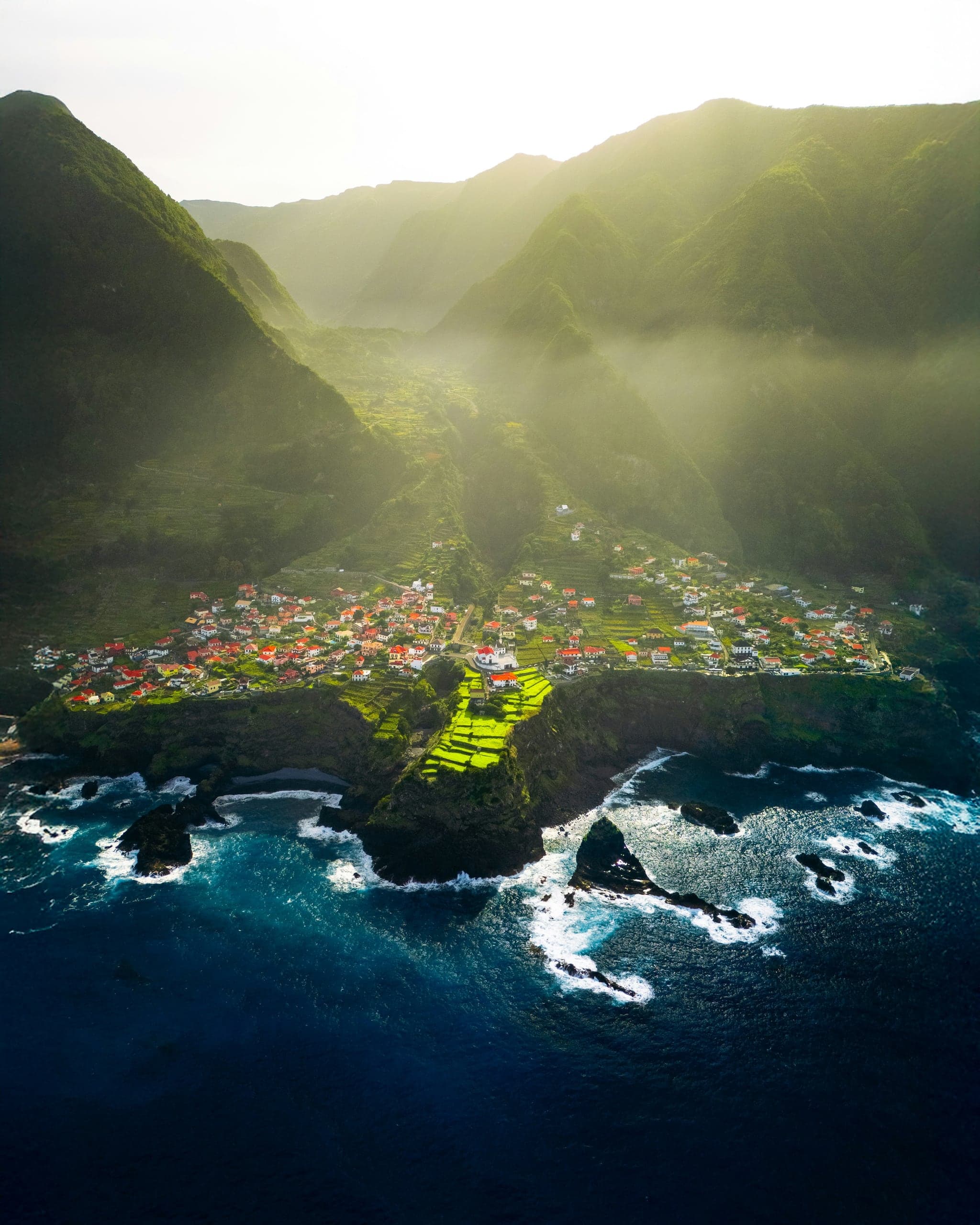 Seixal village compressed between Madeira's green north-coast cliffs and the Atlantic
