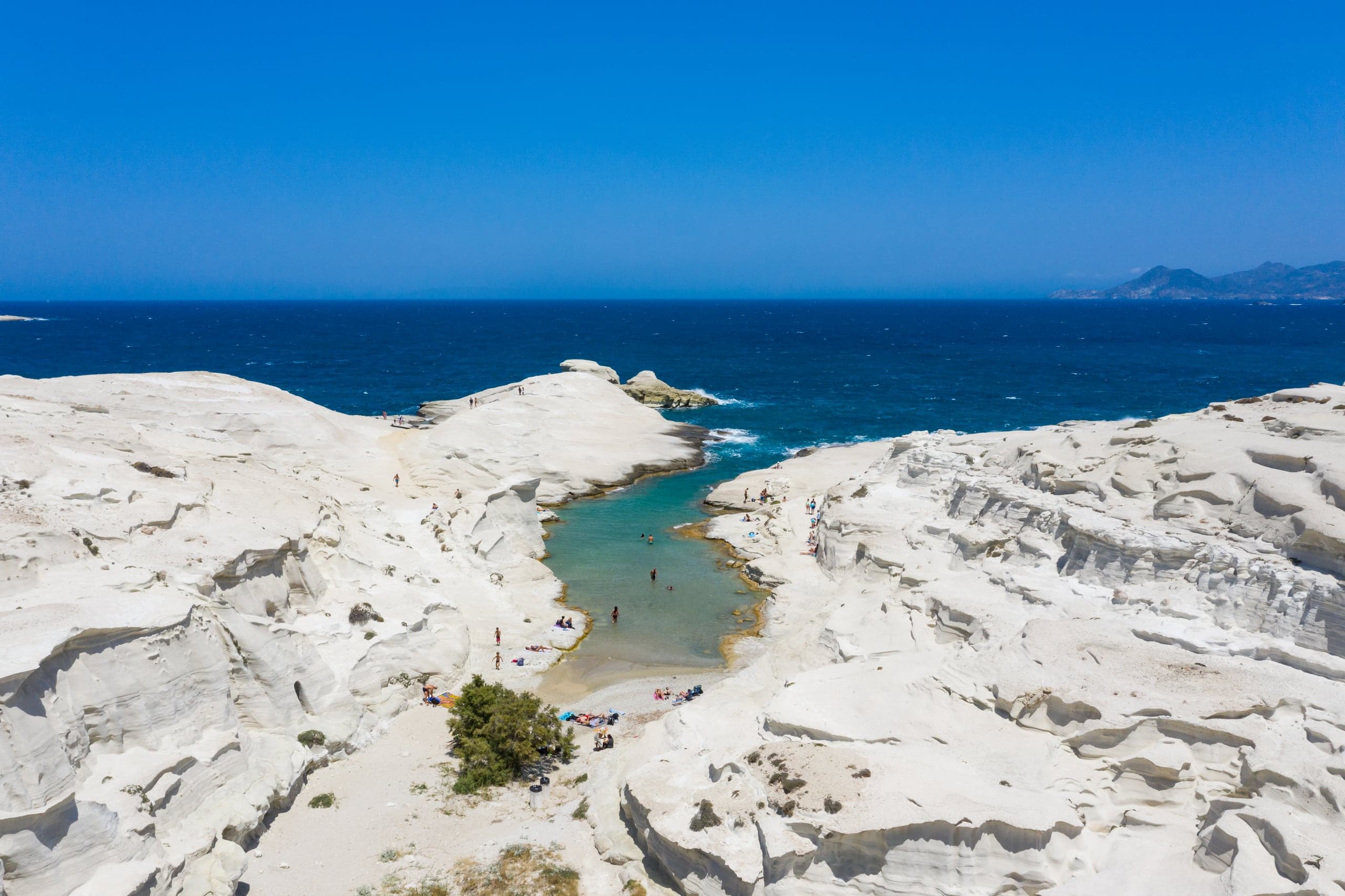 Turquoise inlet through Sarakiniko's white volcanic rock