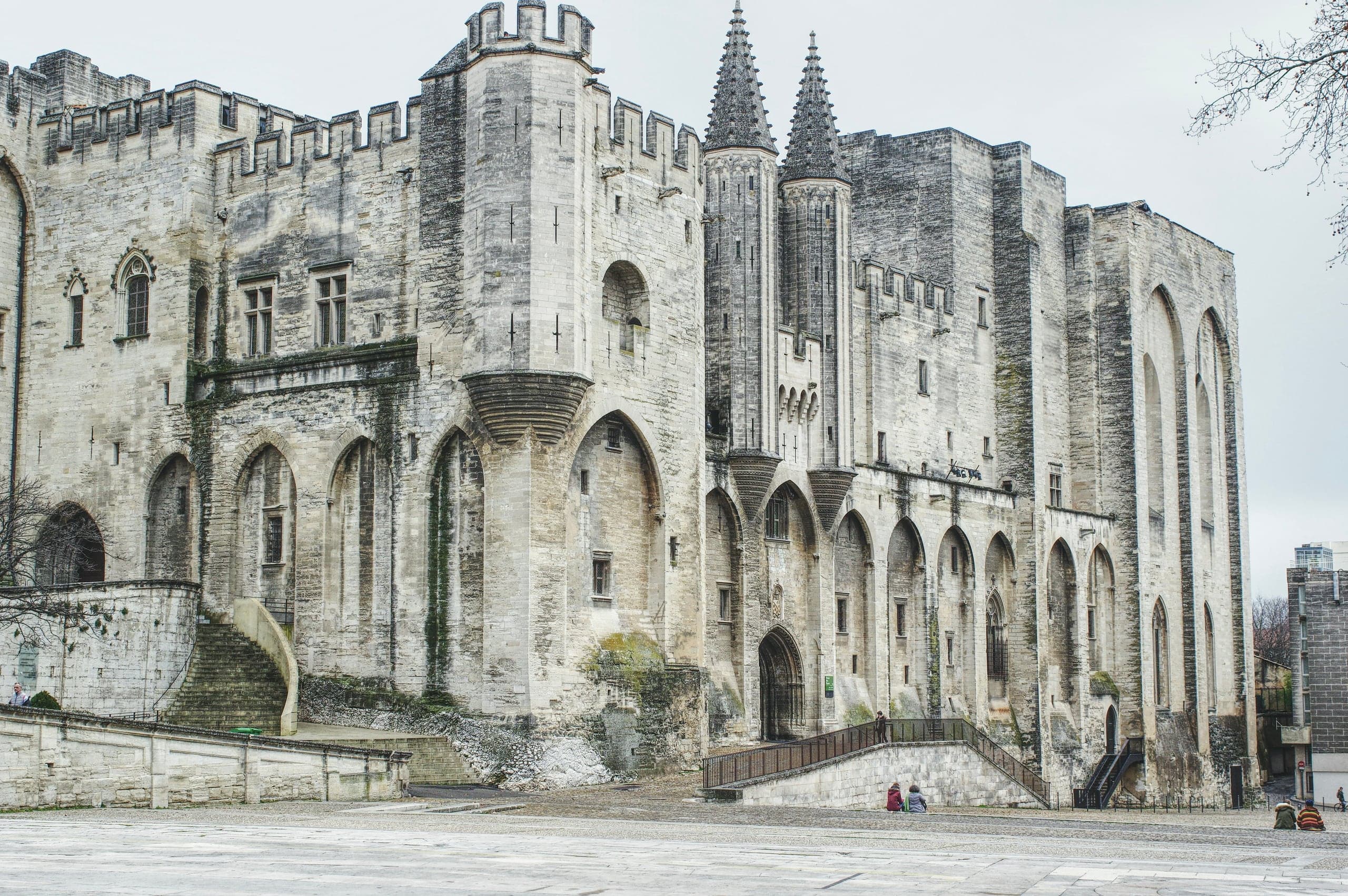 Stone facade and towers of the Palais des Papes in Avignon