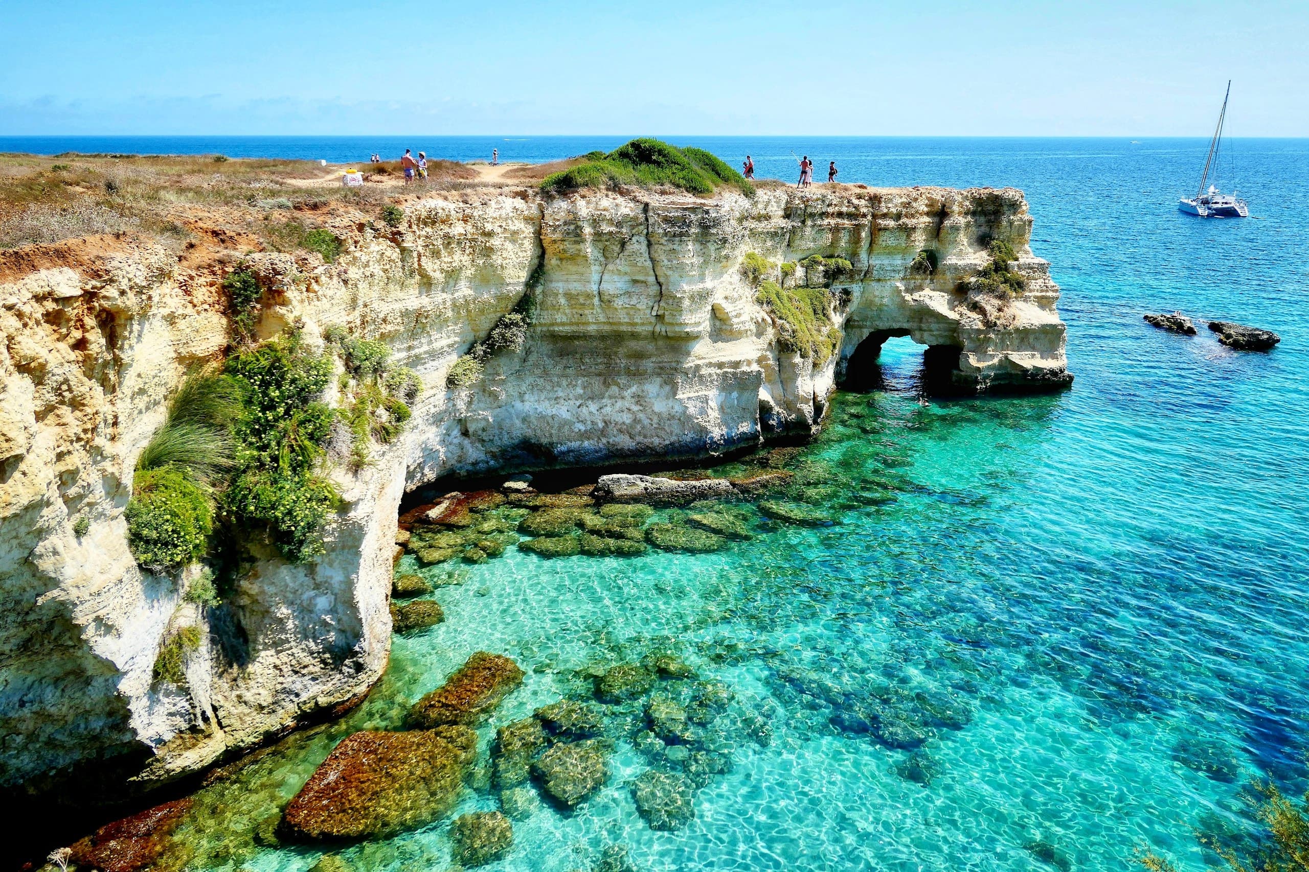brown rock formation on blue sea during daytime
