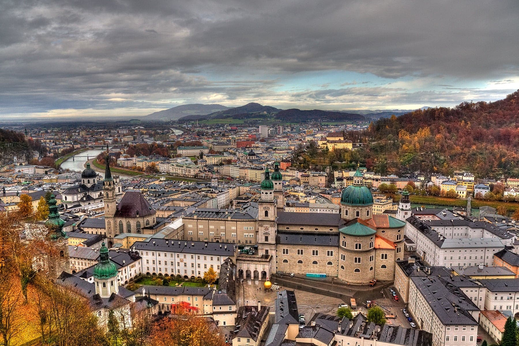 Salzburg's Baroque old town spreads beneath dramatic clouds, seen from Hohensalzburg Fortress